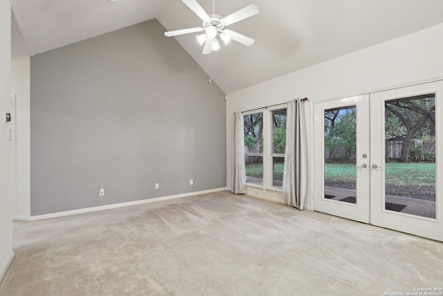 unfurnished room featuring light carpet, french doors, high vaulted ceiling, and ceiling fan