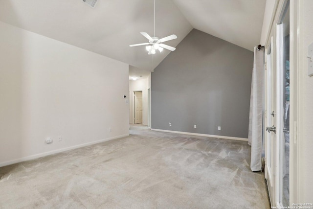 empty room featuring ceiling fan, light colored carpet, and vaulted ceiling