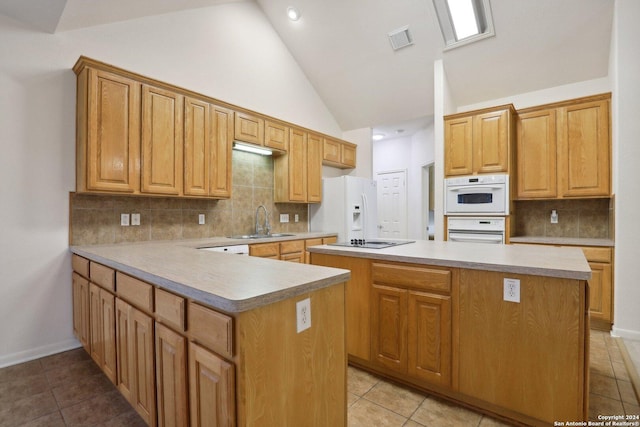 kitchen with decorative backsplash, a center island, white appliances, and sink