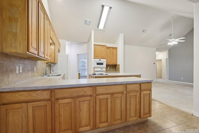 kitchen with sink, backsplash, ceiling fan, and light tile patterned flooring