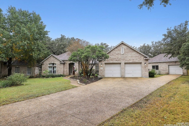 view of front of property featuring a garage and a front yard