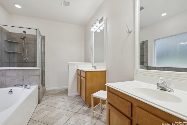 bathroom featuring vanity and shower with separate bathtub