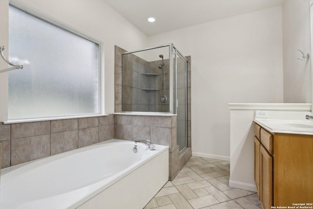 bathroom featuring vanity and separate shower and tub