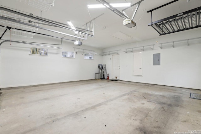 garage featuring electric panel and a garage door opener