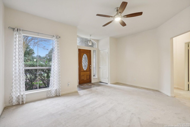 carpeted entrance foyer with ceiling fan