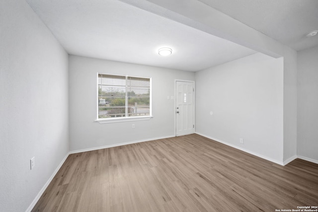 empty room with hardwood / wood-style floors