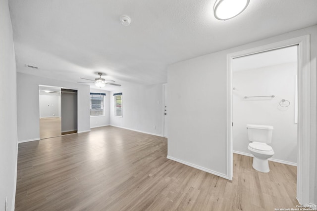 interior space with a textured ceiling, light hardwood / wood-style flooring, and ceiling fan