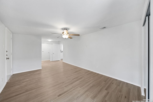 spare room with ceiling fan and hardwood / wood-style flooring