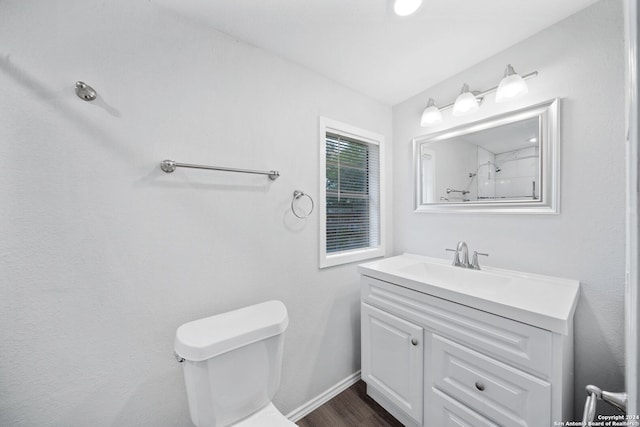 bathroom featuring hardwood / wood-style flooring, vanity, and toilet