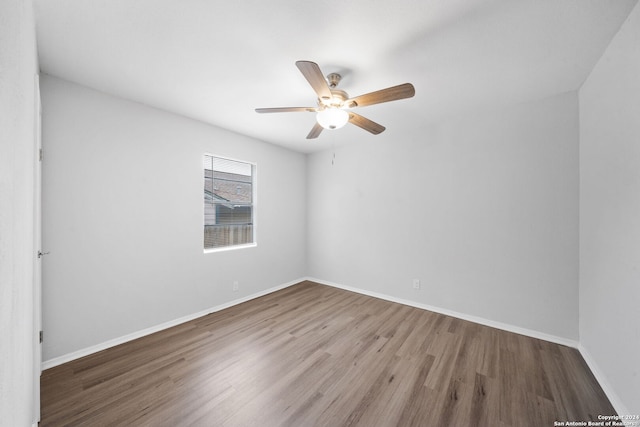 unfurnished room with ceiling fan and hardwood / wood-style flooring