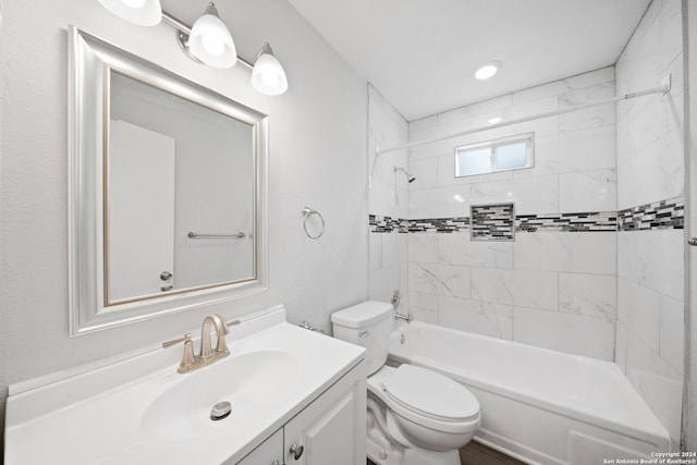 full bathroom with vanity, toilet, and tiled shower / bath