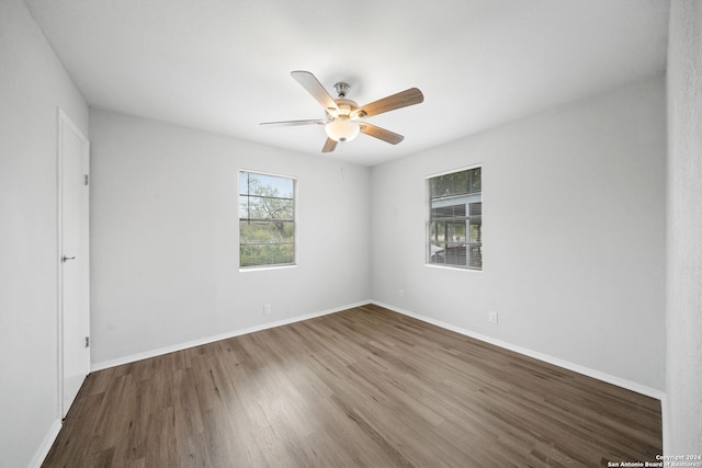 unfurnished room with hardwood / wood-style flooring and ceiling fan