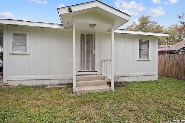 property entrance with a yard