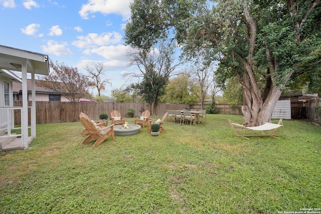 view of yard with a fire pit