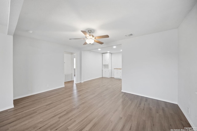 unfurnished room featuring ceiling fan and light hardwood / wood-style floors