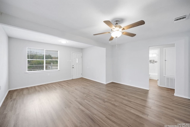 spare room with ceiling fan and hardwood / wood-style flooring