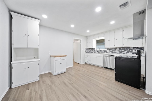 kitchen with dishwasher, white cabinets, light hardwood / wood-style flooring, and wall chimney exhaust hood