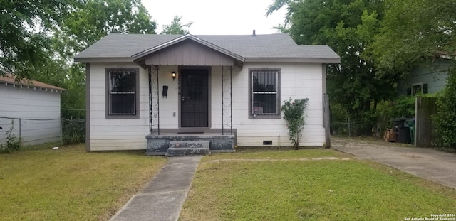 bungalow-style home with a front lawn