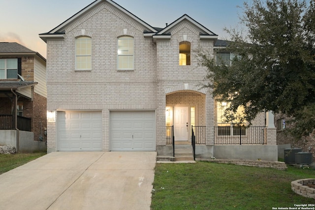 french provincial home with a yard, cooling unit, and a garage