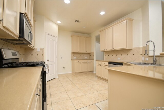 kitchen featuring decorative backsplash, sink, light tile patterned flooring, and appliances with stainless steel finishes