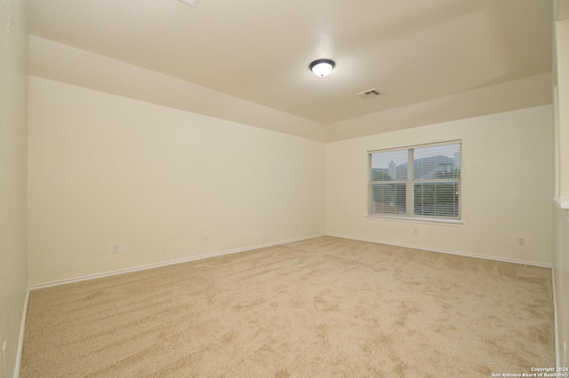 unfurnished room featuring light carpet