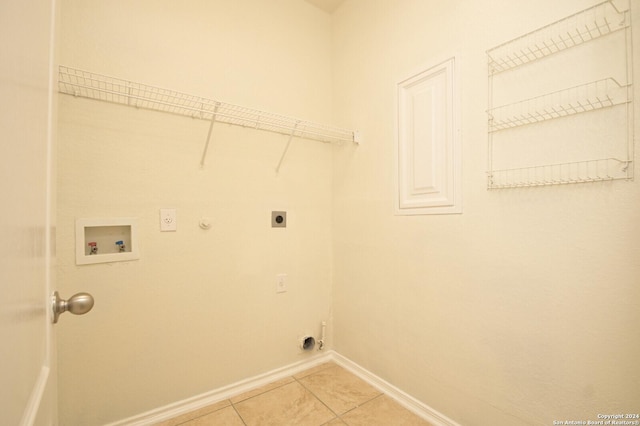 clothes washing area featuring washer hookup, hookup for a gas dryer, electric dryer hookup, and light tile patterned flooring