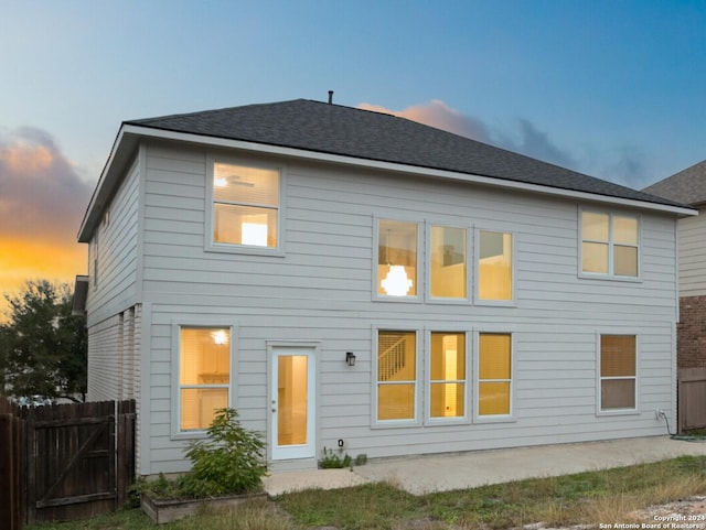 view of back house at dusk