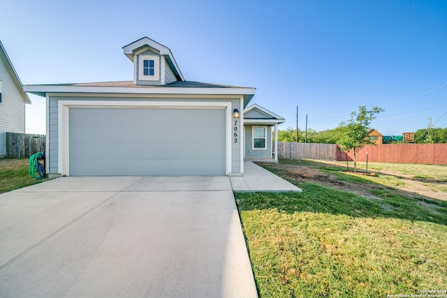 view of front of property with a garage and a front yard