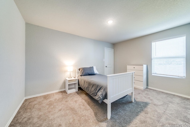 bedroom featuring light carpet