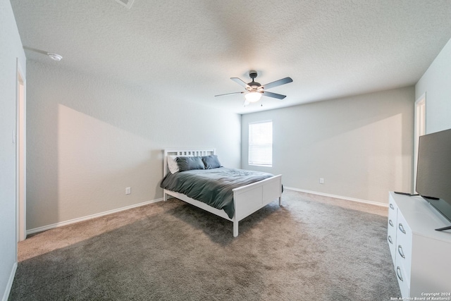 bedroom featuring ceiling fan, a textured ceiling, and dark colored carpet