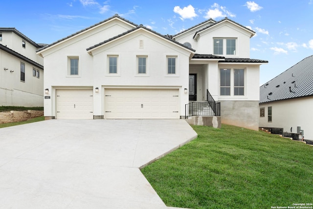 view of front of home featuring a front lawn and a garage