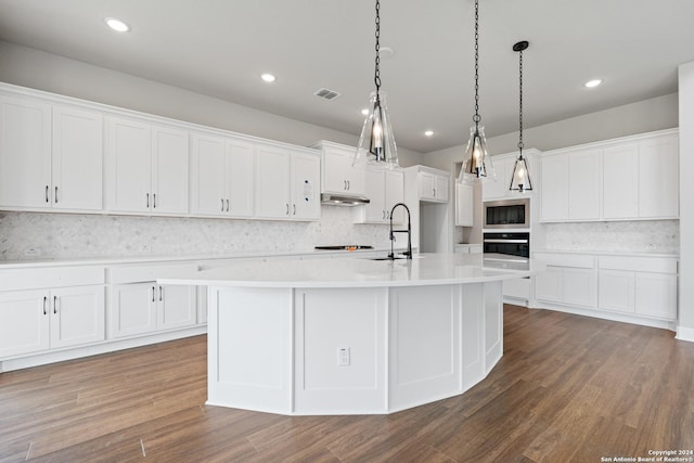 kitchen featuring white cabinets, black appliances, an island with sink, and sink