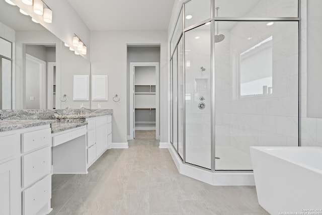 bathroom with independent shower and bath and vanity