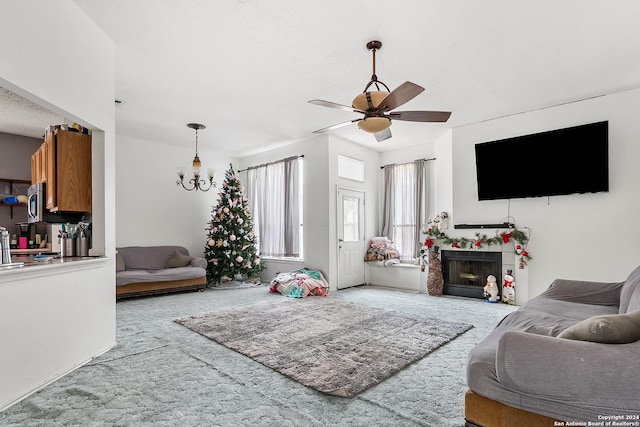 living room featuring light carpet and ceiling fan with notable chandelier