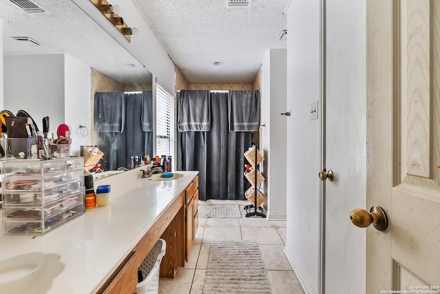 bathroom featuring tile patterned floors, vanity, a shower with curtain, and a textured ceiling