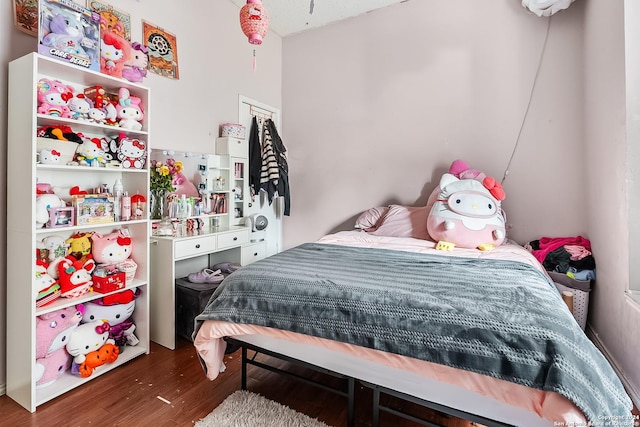 bedroom with dark hardwood / wood-style flooring