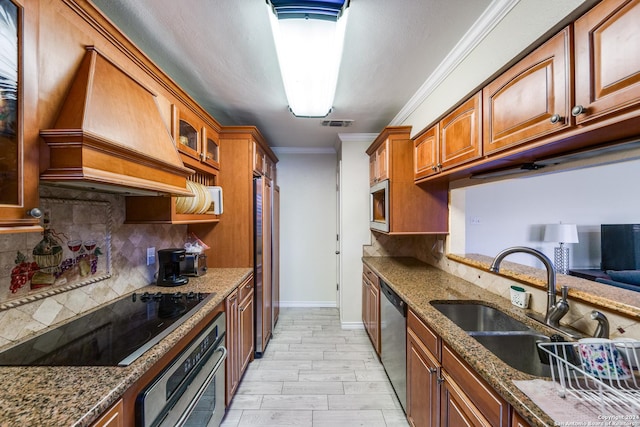 kitchen featuring sink, built in appliances, stone countertops, custom exhaust hood, and ornamental molding