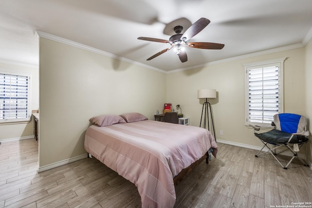 bedroom with light hardwood / wood-style floors, ceiling fan, and crown molding