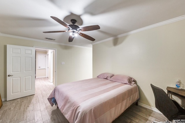 bedroom featuring hardwood / wood-style flooring, ceiling fan, and ornamental molding