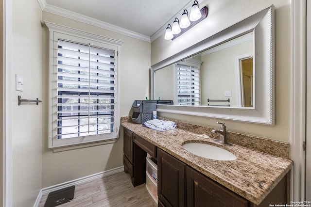 bathroom featuring wood-type flooring, vanity, and crown molding