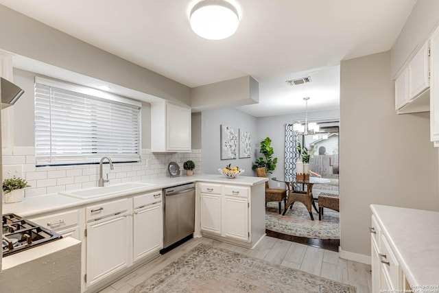 kitchen with sink, stainless steel appliances, light hardwood / wood-style flooring, kitchen peninsula, and white cabinets