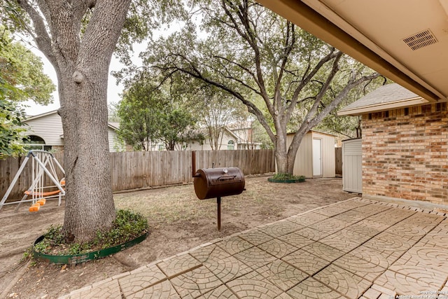 view of patio featuring a storage unit