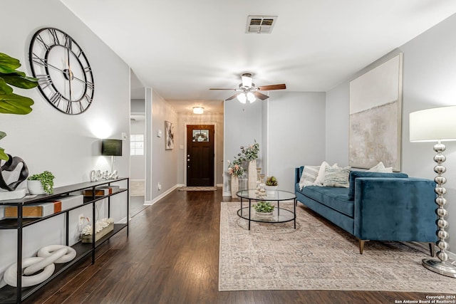 living room with ceiling fan and dark hardwood / wood-style flooring