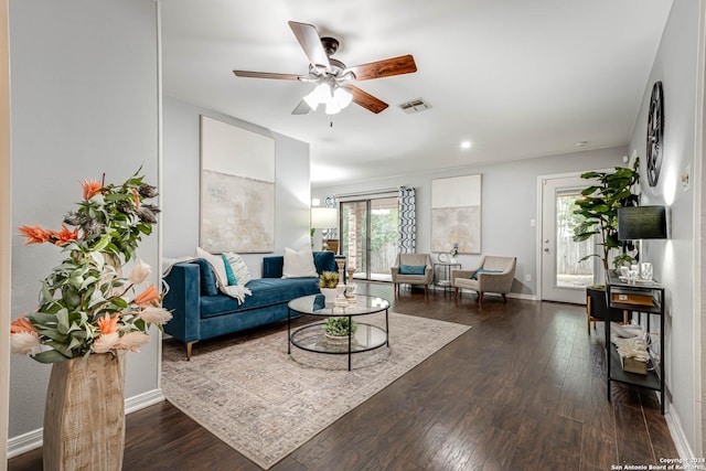 living room featuring ceiling fan and dark hardwood / wood-style flooring