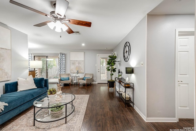 living room with ceiling fan and dark hardwood / wood-style flooring