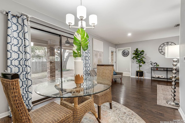 dining space with a chandelier and dark hardwood / wood-style floors