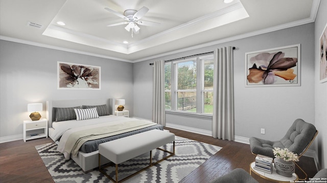 bedroom with a tray ceiling, ceiling fan, dark hardwood / wood-style flooring, and ornamental molding