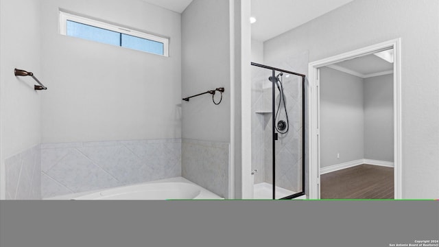 bathroom with ornamental molding, independent shower and bath, and hardwood / wood-style flooring