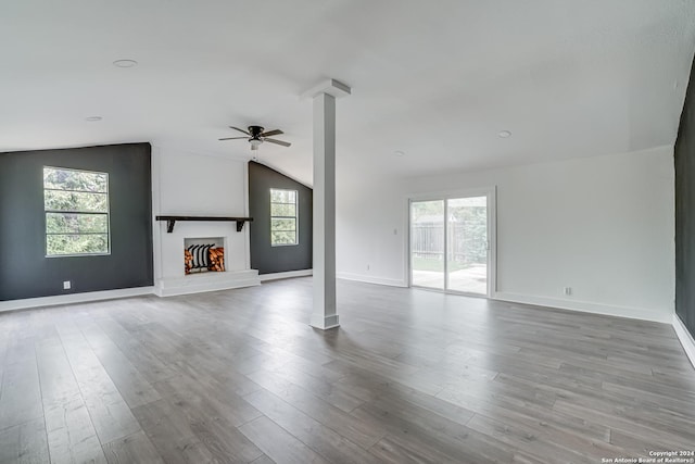 unfurnished living room with ceiling fan, lofted ceiling, and light hardwood / wood-style flooring