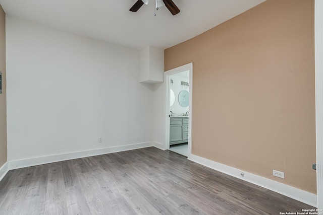 empty room with ceiling fan and hardwood / wood-style flooring